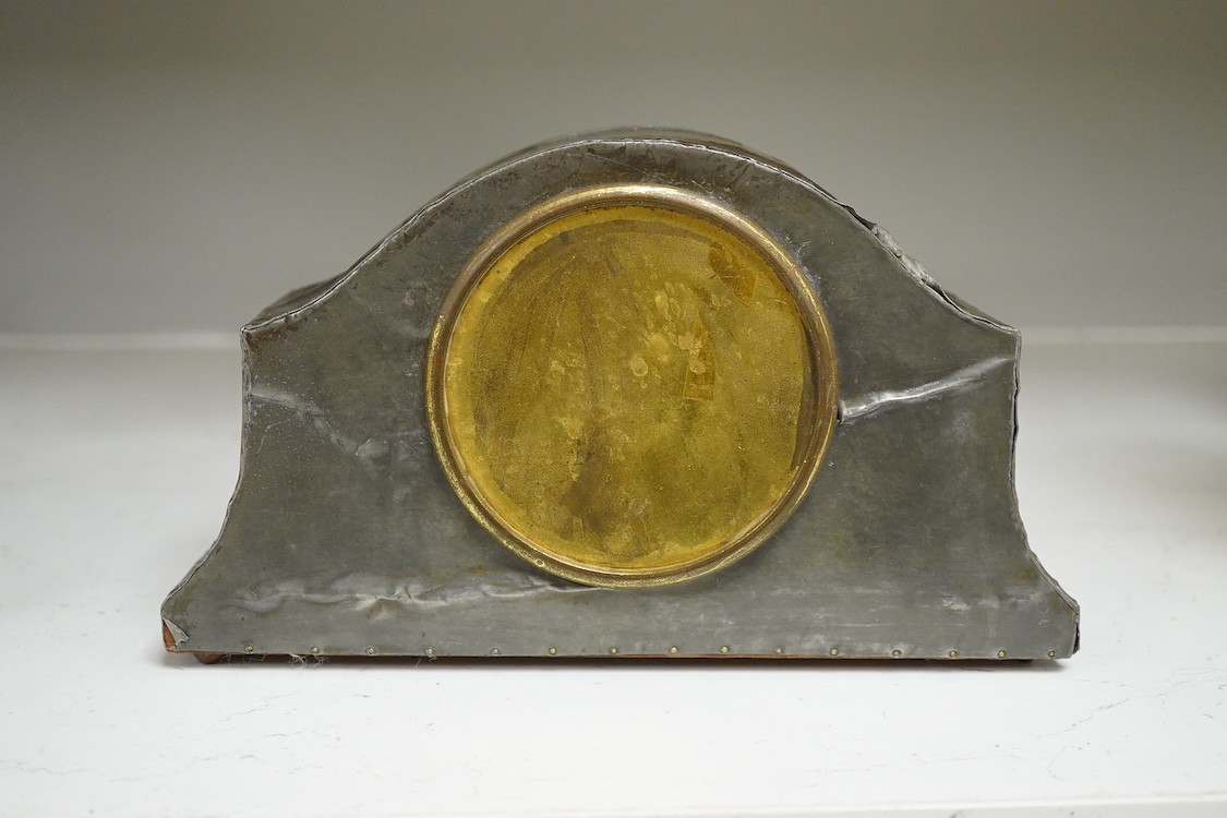 A pewter mantel timepiece with key, 22cm wide